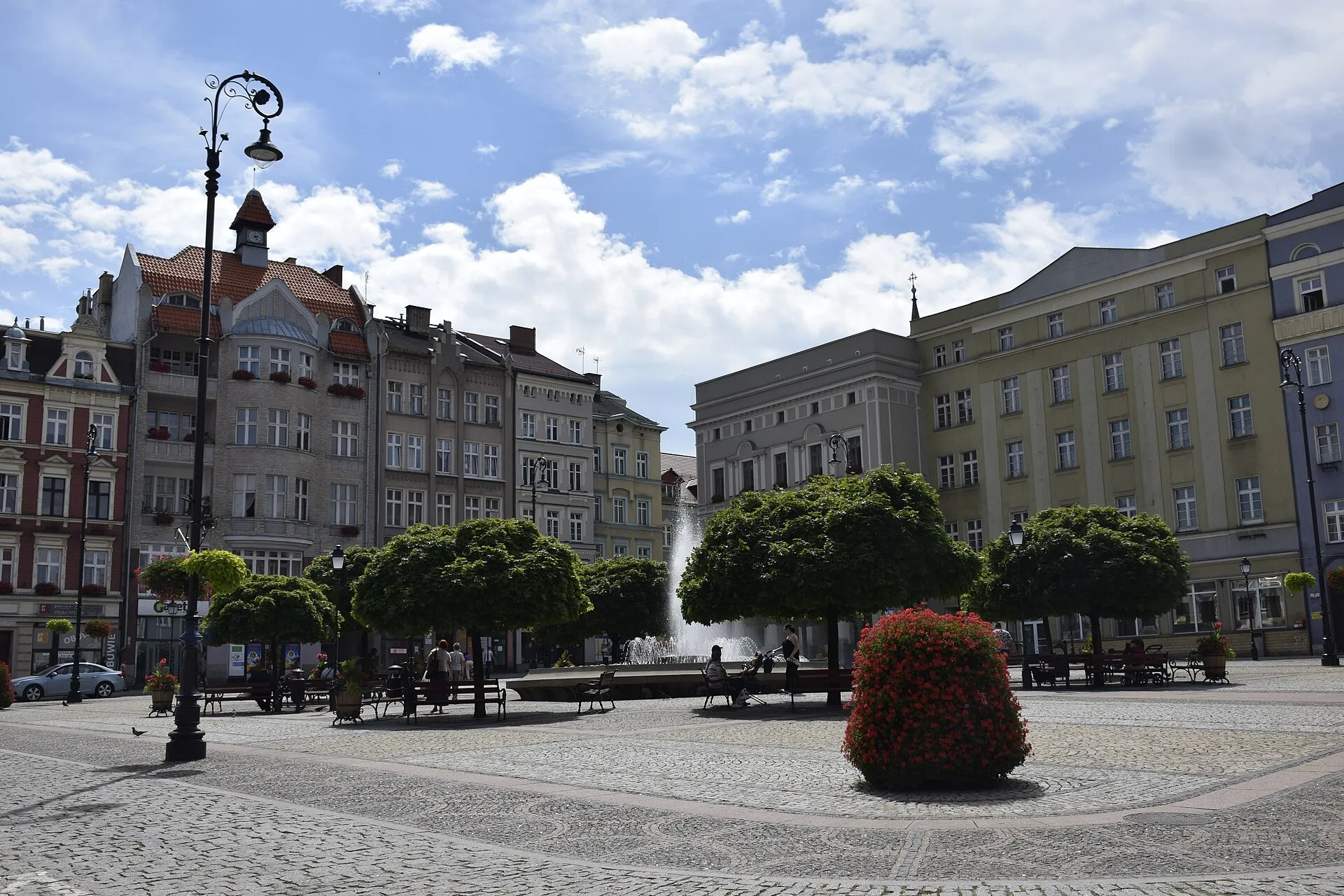 Rynek w Wałbrzychu z kamienicami, fontanną i drzewami w 2019 roku